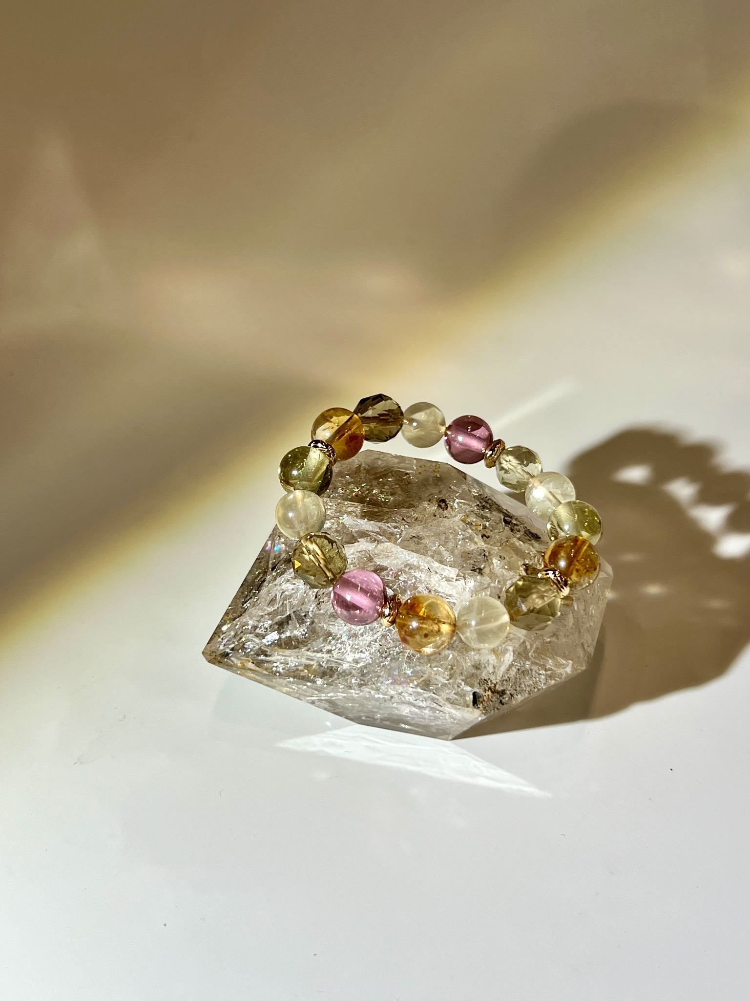 Natural double‑terminated Herkimer Diamond standing on display base with internal ice fractures and light refraction.