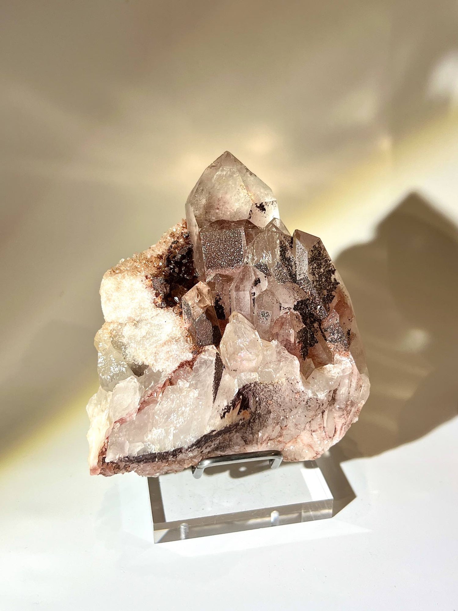 Tanzanian Red Phantom Quartz cluster with Hematite microcrystals, showing clear crystal points and red phantom layers.
